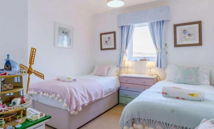 We made the twin room suitable for little people but pretty enough for older guests too!  It has kiddy surprises in the wardrobe and a chest of drawer